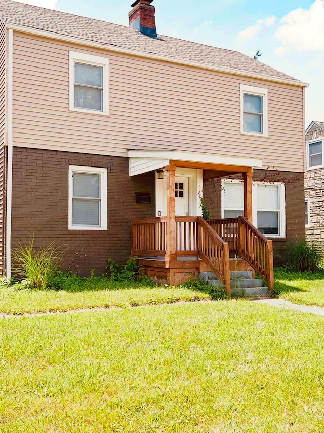1417 E Whittier St, Columbus, OH 43206 - view of front of house with a front lawn, a chimney, and brick siding