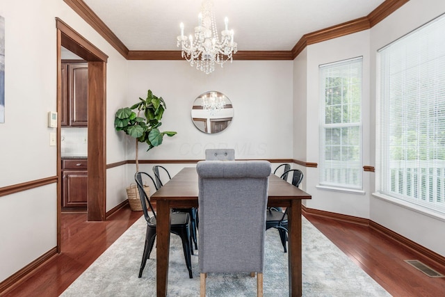 6923 Bishops Crossing Cir, Dublin, OH 43016 - dining area with a chandelier, dark wood-style flooring, and crown molding