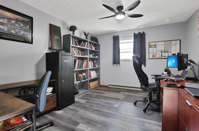 12232 Cleo Rd, Orient, OH 43146 - office space with baseboard heating, a ceiling fan, wood finished floors, and a textured ceiling