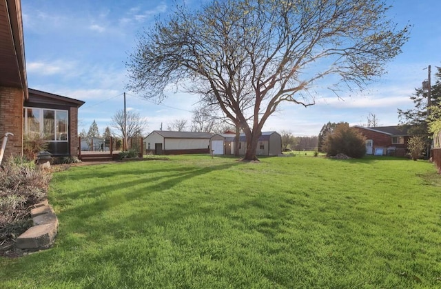 12232 Cleo Rd, Orient, OH 43146 - view of green lawn featuring a wooden deck and an outdoor structure
