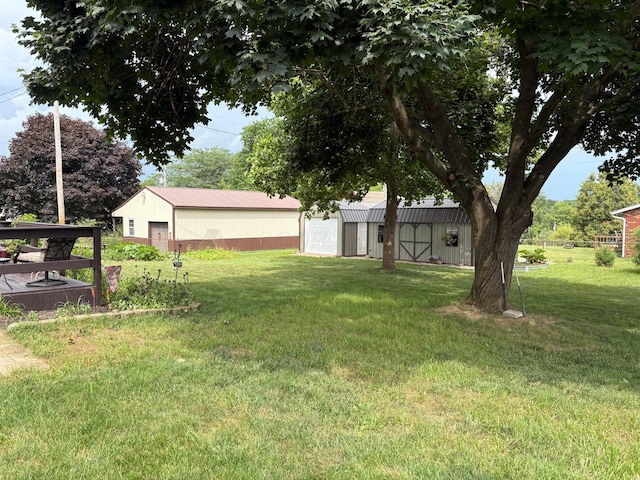 12232 Cleo Rd, Orient, OH 43146 - view of green lawn featuring a detached garage and an outbuilding