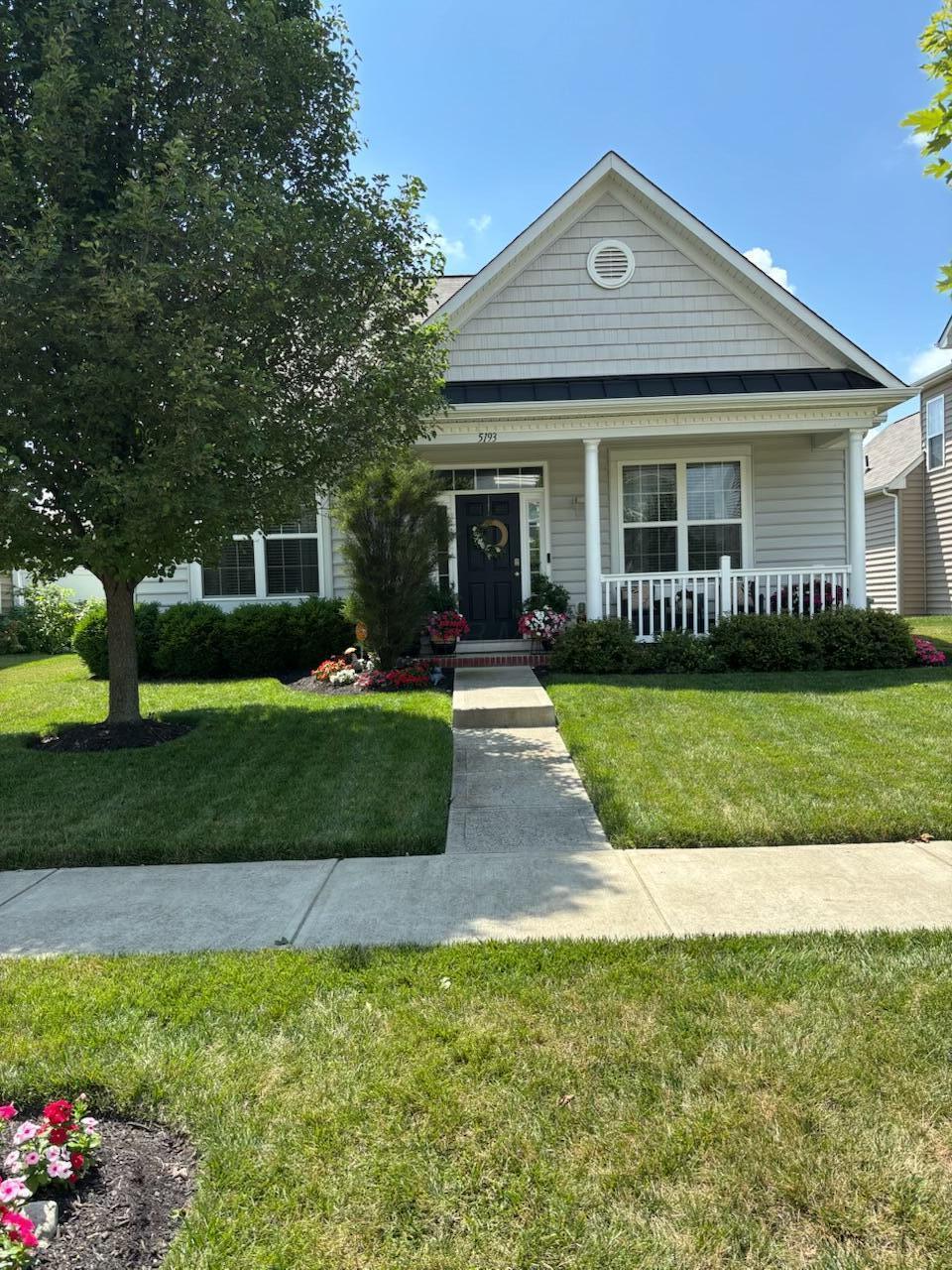 5193 Wildcat Falls Dr, Dublin, OH 43016 - view of front of house with a front yard and a porch