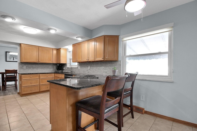 6146 Catawba Dr, Grove City, OH 43123 - kitchen with light tile patterned floors, decorative backsplash, healthy amount of natural light, and a ceiling fan
