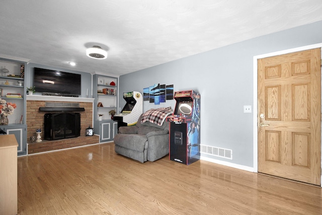 6146 Catawba Dr, Grove City, OH 43123 - living area featuring wood finished floors, a brick fireplace, and built in features
