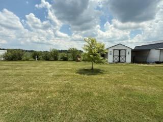 521 Kenton Galion Rd E, Marion, OH 43302 - view of grassy yard with a shed and a carport