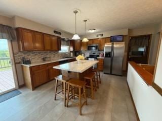 521 Kenton Galion Rd E, Marion, OH 43302 - kitchen featuring stainless steel appliances, plenty of natural light, and brown cabinets