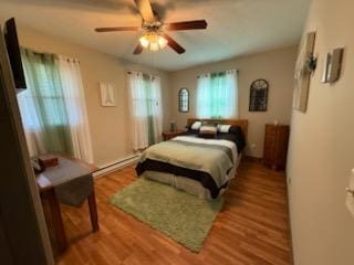 521 Kenton Galion Rd E, Marion, OH 43302 - bedroom with a baseboard radiator and wood finished floors