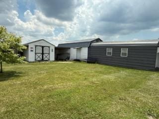 521 Kenton Galion Rd E, Marion, OH 43302 - back of property featuring a storage unit, a yard, and a carport