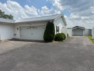 521 Kenton Galion Rd E, Marion, OH 43302 - view of home's exterior featuring an attached garage and asphalt driveway