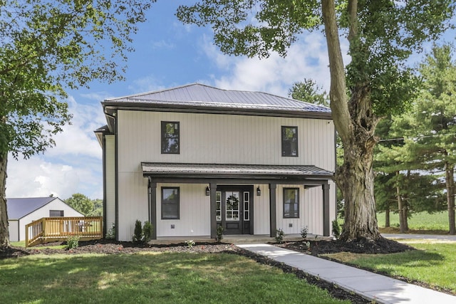 10123 Loop Rd, Millersport, OH 43046 - modern inspired farmhouse featuring a porch, a front yard, a metal roof, a wooden deck, and a standing seam roof