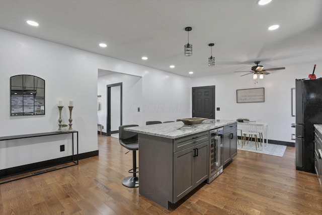 10123 Loop Rd, Millersport, OH 43046 - kitchen with wine cooler, a ceiling fan, a kitchen bar, dark wood-style flooring, and gray cabinets