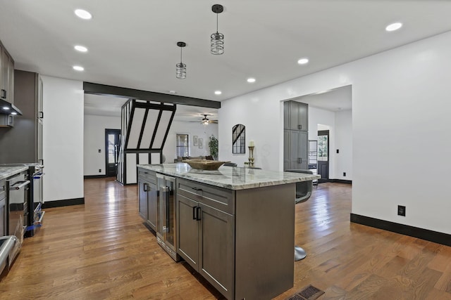 10123 Loop Rd, Millersport, OH 43046 - kitchen with a kitchen bar, wood finished floors, wine cooler, a ceiling fan, and recessed lighting