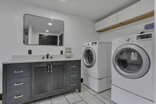 10123 Loop Rd, Millersport, OH 43046 - washroom featuring separate washer and dryer, cabinet space, and light marble finish flooring