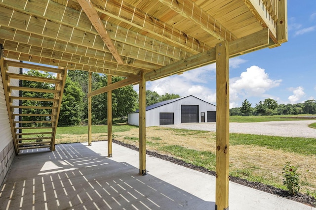 10123 Loop Rd, Millersport, OH 43046 - view of patio featuring a garage and an outbuilding