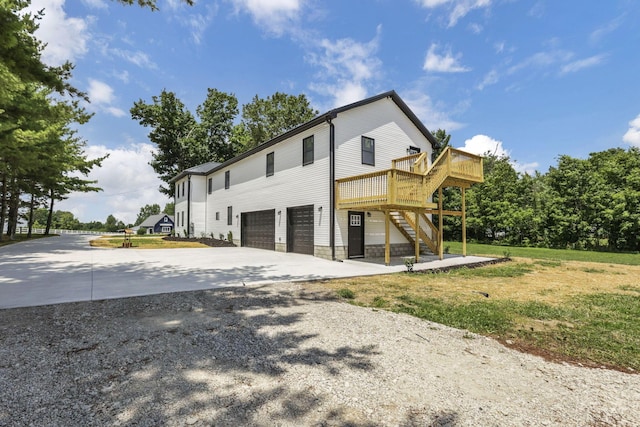 10123 Loop Rd, Millersport, OH 43046 - view of property exterior with driveway, an attached garage, stairway, and a wooden deck