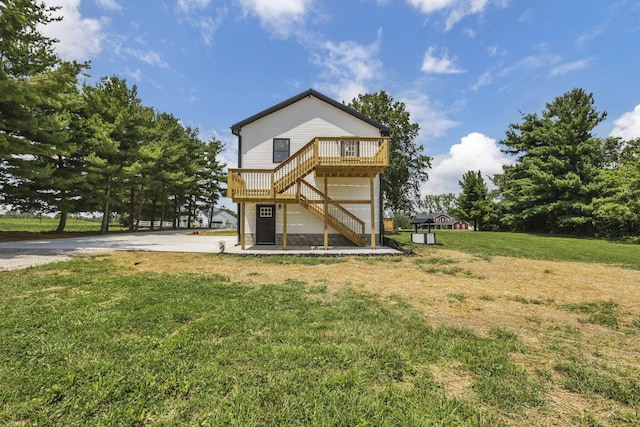 10123 Loop Rd, Millersport, OH 43046 - rear view of house featuring stairs, a wooden deck, a lawn, and driveway