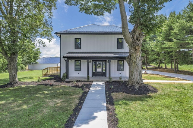 10123 Loop Rd, Millersport, OH 43046 - view of front of home with covered porch, a front yard, and a metal roof
