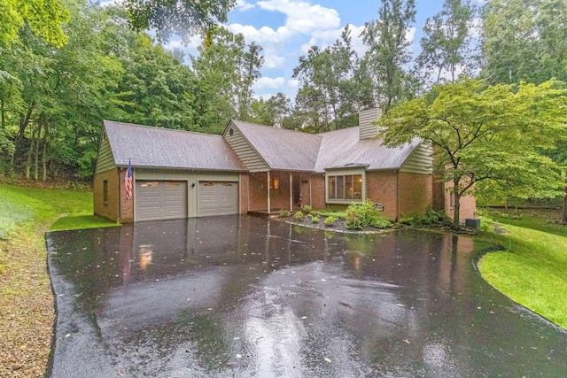 976 Hillside Dr, Newark, OH 43055 - single story home with a garage, driveway, brick siding, a chimney, and a front lawn