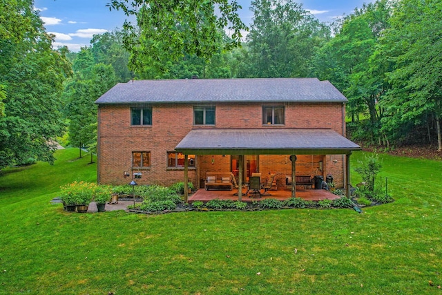 976 Hillside Dr, Newark, OH 43055 - back of property with a yard, a patio area, brick siding, and a view of trees