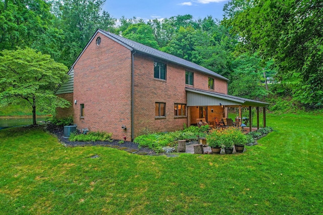 976 Hillside Dr, Newark, OH 43055 - back of property featuring brick siding, a patio, and a lawn