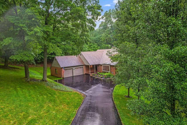 976 Hillside Dr, Newark, OH 43055 - view of front of home featuring asphalt driveway, an attached garage, a front yard, and brick siding