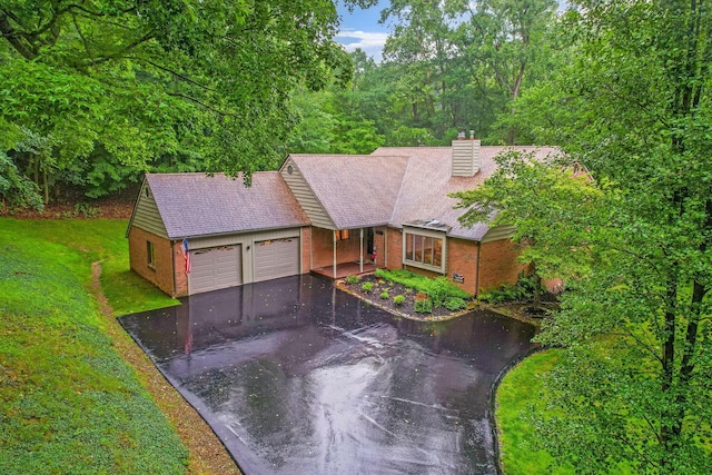 976 Hillside Dr, Newark, OH 43055 - ranch-style home with a garage, driveway, brick siding, a chimney, and a front lawn
