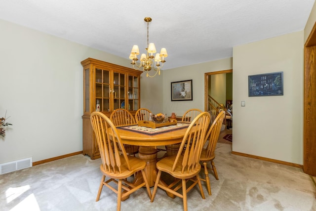 976 Hillside Dr, Newark, OH 43055 - dining room with a chandelier, light colored carpet, a textured ceiling, and stairway