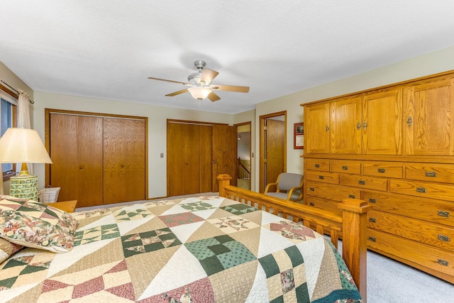 976 Hillside Dr, Newark, OH 43055 - bedroom with two closets, light colored carpet, and a ceiling fan