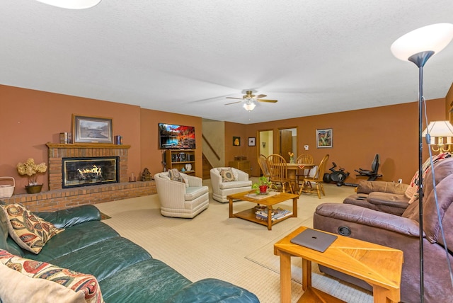 976 Hillside Dr, Newark, OH 43055 - carpeted living room featuring a ceiling fan, stairs, a textured ceiling, and a fireplace