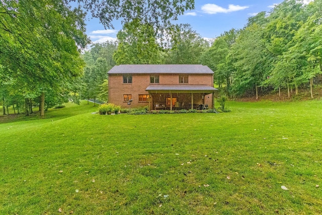 976 Hillside Dr, Newark, OH 43055 - back of property featuring a yard, a view of trees, and brick siding