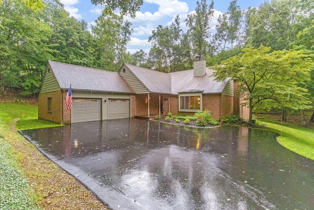 976 Hillside Dr, Newark, OH 43055 - ranch-style home featuring a garage, driveway, a chimney, brick siding, and a front yard