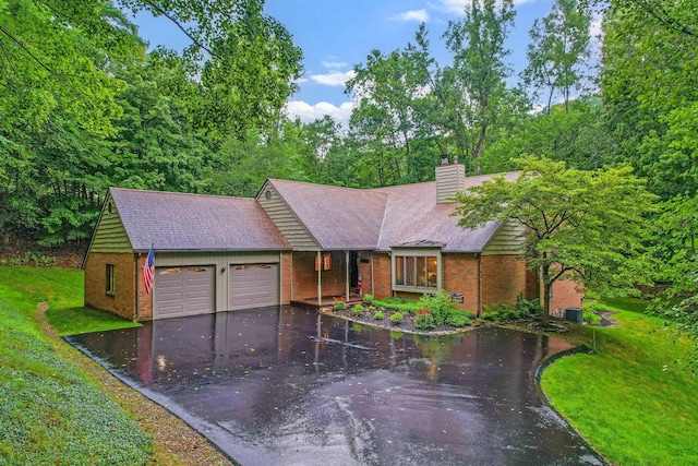 976 Hillside Dr, Newark, OH 43055 - view of front of property with brick siding, an attached garage, driveway, a front lawn, and a chimney