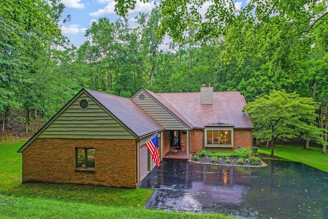 976 Hillside Dr, Newark, OH 43055 - view of front of home with brick siding, a chimney, asphalt driveway, and a front yard