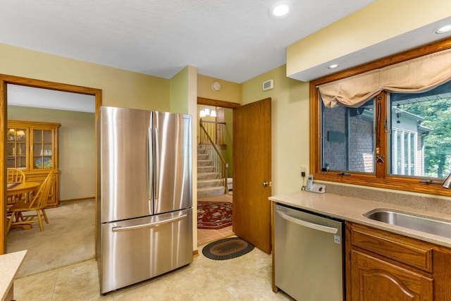 976 Hillside Dr, Newark, OH 43055 - kitchen with stainless steel appliances, light countertops, brown cabinets, light tile patterned flooring, and recessed lighting