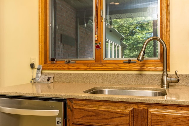 976 Hillside Dr, Newark, OH 43055 - kitchen view of stainless steel dishwasher, brown cabinetry, and light countertops