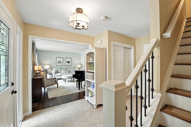 371 Ashworth Ct, Dublin, OH 43017 - foyer entrance featuring stairway, light tile patterned flooring, and a chandelier