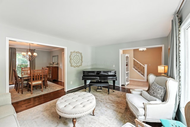371 Ashworth Ct, Dublin, OH 43017 - living room featuring a chandelier, wood finished floors, and stairs