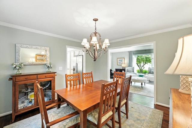 371 Ashworth Ct, Dublin, OH 43017 - dining area with crown molding, dark wood-style flooring, and a chandelier