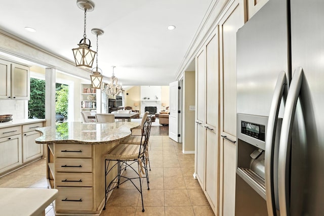 371 Ashworth Ct, Dublin, OH 43017 - kitchen featuring stainless steel fridge with ice dispenser, a kitchen island, light tile patterned floors, open floor plan, and a chandelier
