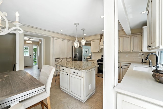 371 Ashworth Ct, Dublin, OH 43017 - kitchen featuring backsplash, appliances with stainless steel finishes, light tile patterned floors, a kitchen island, and recessed lighting