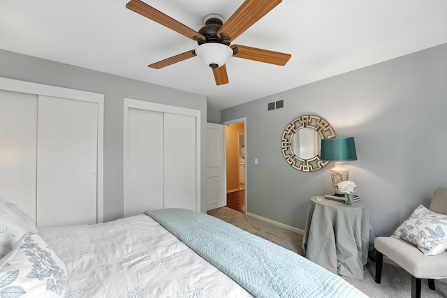 371 Ashworth Ct, Dublin, OH 43017 - bedroom with carpet floors, two closets, and a ceiling fan