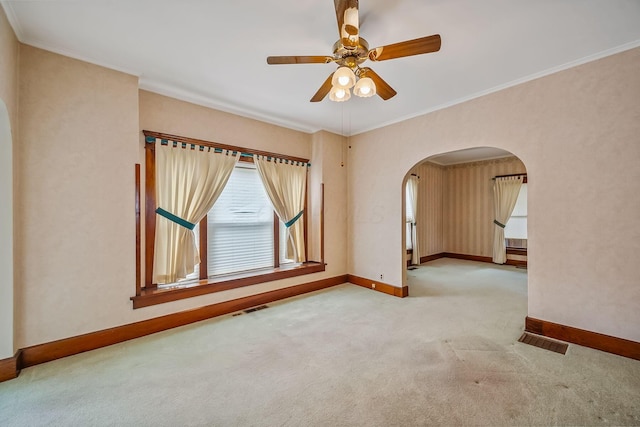 126 Dix Ave, Marion, OH 43302 - carpeted empty room featuring arched walkways, ceiling fan, and ornamental molding