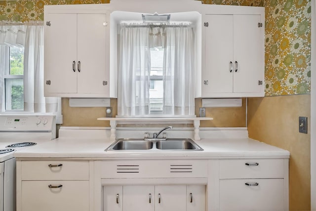 126 Dix Ave, Marion, OH 43302 - kitchen with wallpapered walls, white electric range, white cabinets, and light countertops