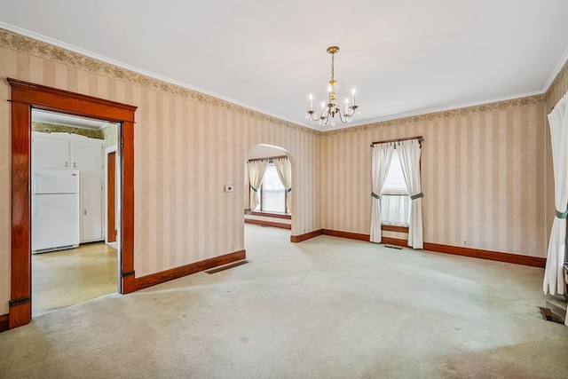 126 Dix Ave, Marion, OH 43302 - unfurnished room with wallpapered walls, a chandelier, plenty of natural light, crown molding, and arched walkways