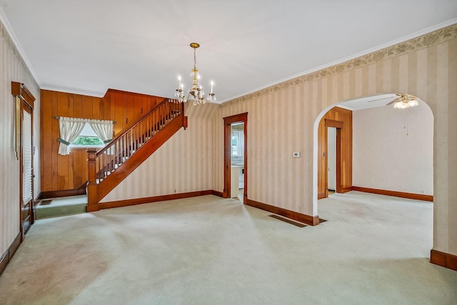 126 Dix Ave, Marion, OH 43302 - unfurnished living room featuring crown molding, wallpapered walls, arched walkways, carpet, and a chandelier