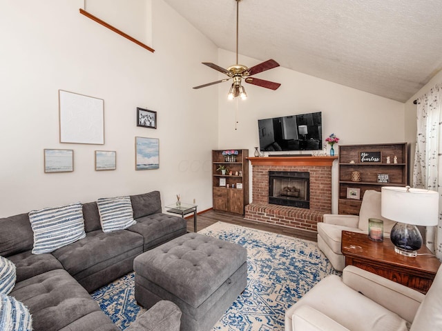 238 Key Blvd, Pataskala, OH 43062 - living area featuring lofted ceiling, ceiling fan, wood finished floors, a fireplace, and a textured ceiling