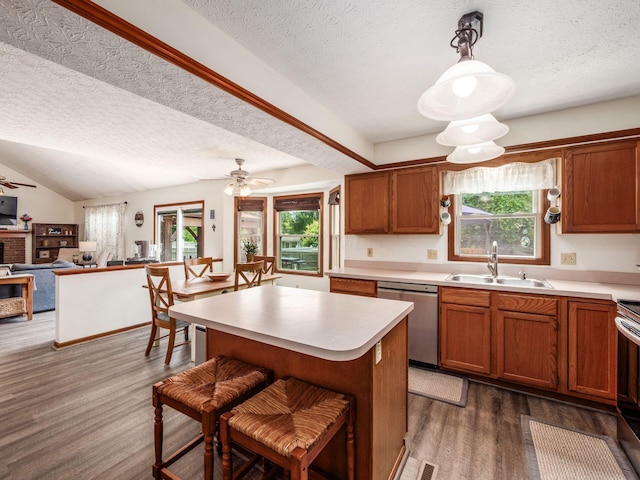 238 Key Blvd, Pataskala, OH 43062 - kitchen with dishwasher, a textured ceiling, healthy amount of natural light, light countertops, and dark wood-type flooring