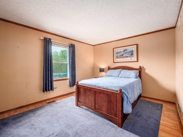 238 Key Blvd, Pataskala, OH 43062 - bedroom featuring ornamental molding, light wood finished floors, and a textured ceiling