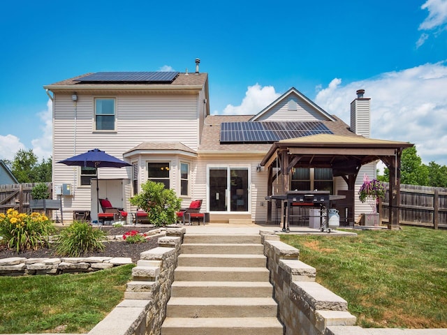 238 Key Blvd, Pataskala, OH 43062 - back of house with a patio area, roof mounted solar panels, a chimney, and a fenced backyard