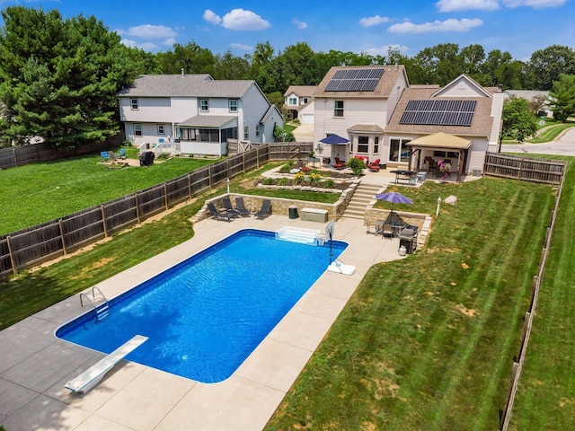 238 Key Blvd, Pataskala, OH 43062 - view of swimming pool with outdoor dining space, a patio area, a fenced backyard, a diving board, and an outdoor fire pit